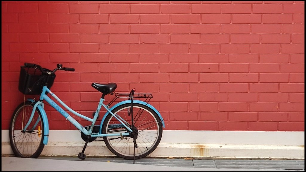 赤いレンガの壁の前にとめた自転車